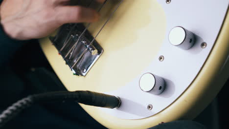 musician inserts jack into output and rotates control knobs