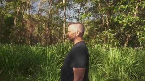 side shot of man walking along nature walk.