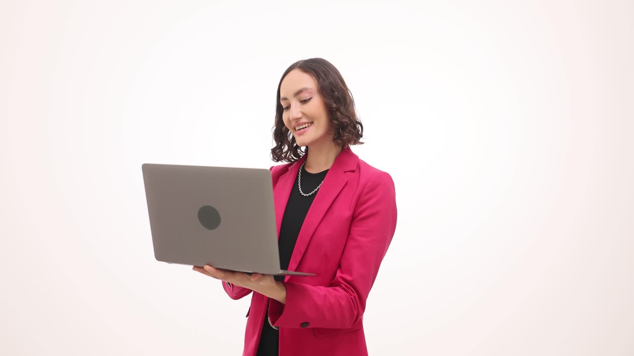 Woman in Pink Blazer Using Laptop