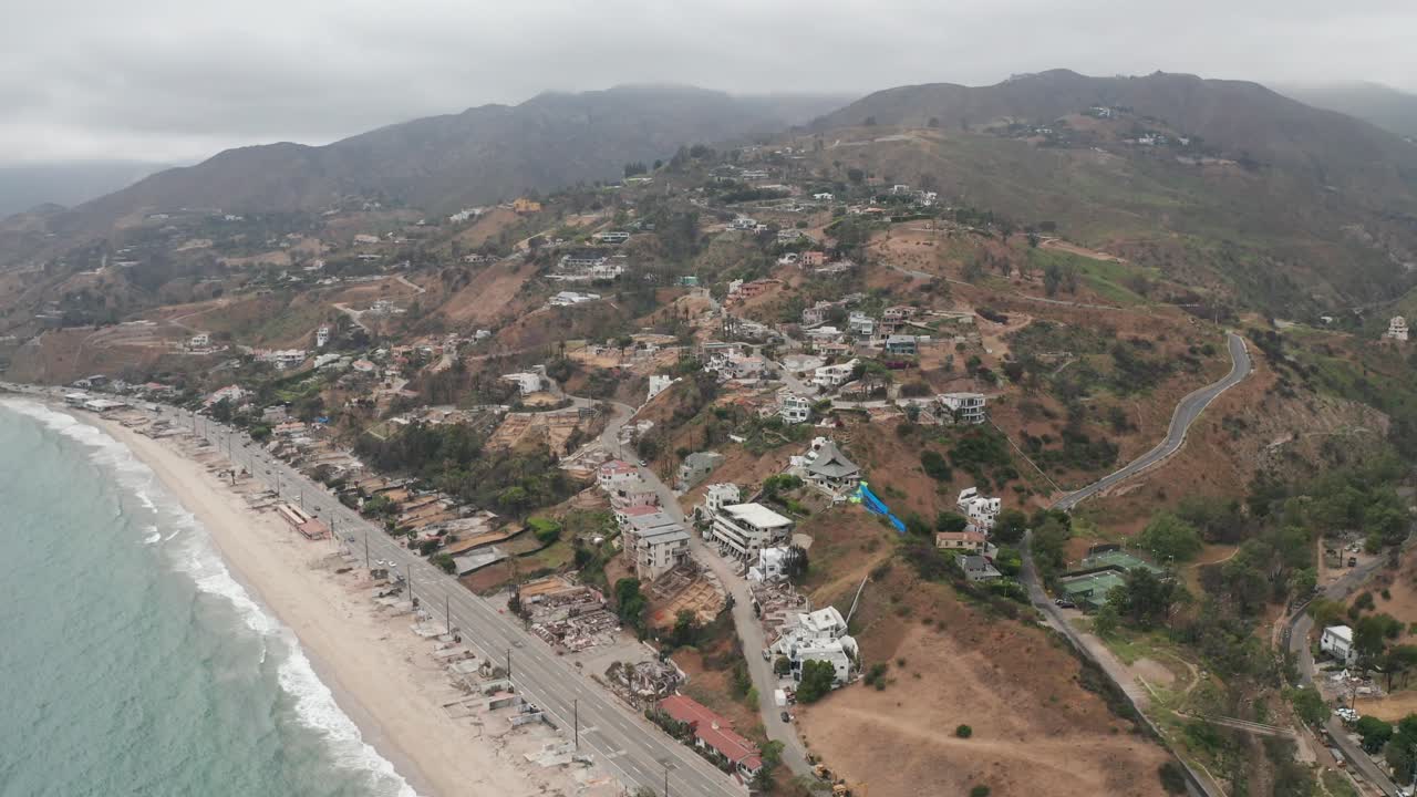 Aerial descending and panning shot of Las Flores Canyon in Malibu after the Palisades Fire in Los Angeles, California. 4K