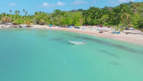 aerial view of beach with anchored boats and parking cars at playa rincon, samana during sunny day