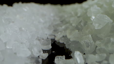 camera backwards crystal coarse sea salt on black mirror table