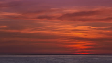 fiery sky at sunrise over sea. timelapse