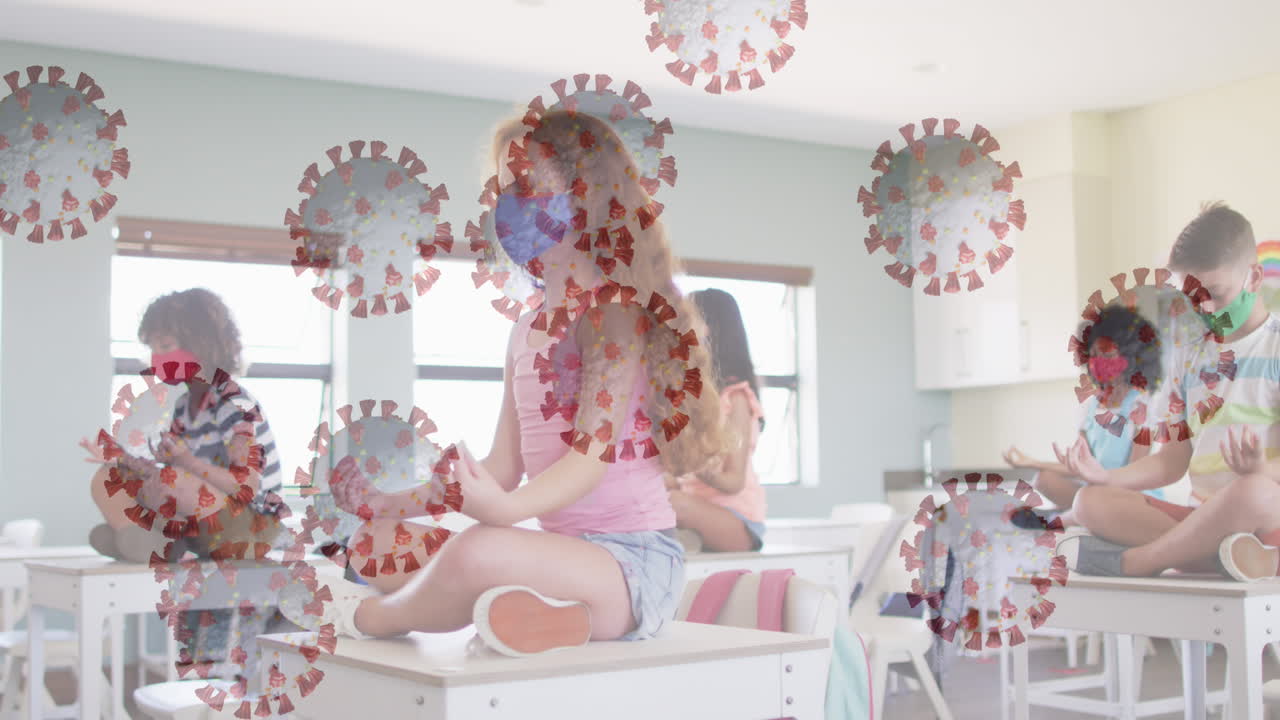 여러 코로나19 세포가 책상 위에 앉아 요가를 연습하는 학생들을 향해 떠다니고 있습니다.