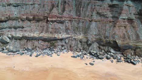 aerial-view-of-rugged-coast-line-and-beach,-left-to-right,-4k