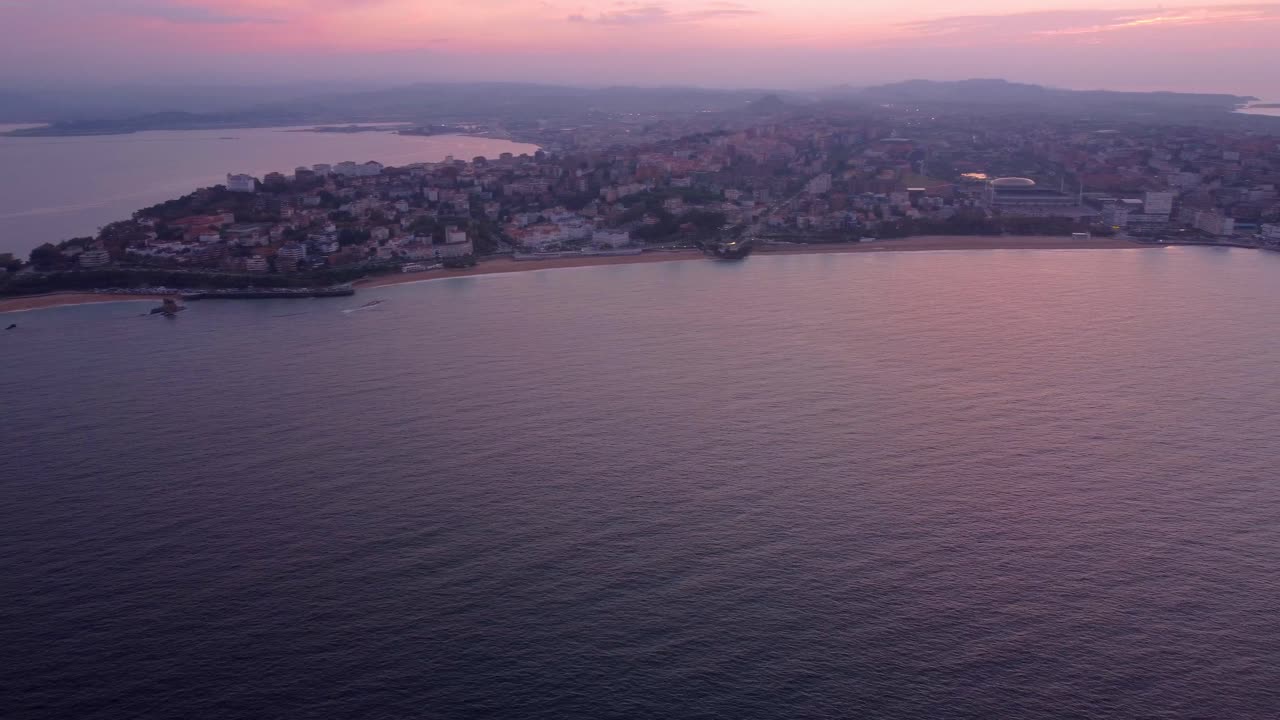 aerial sunset of Santander city of north Spain coastline drone fly above the ocean sandy beach, holiday travel destination