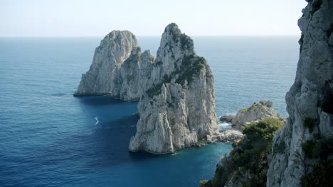 Beautiful-side-view-of-the-Faraglioni-in-Capri,-in-Italy,-the-famous-cliffs-of-this-beautiful-island-during-a-sunny-day-in-spring---02