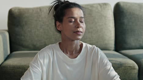 focus woman meditating at home with eyes closed.