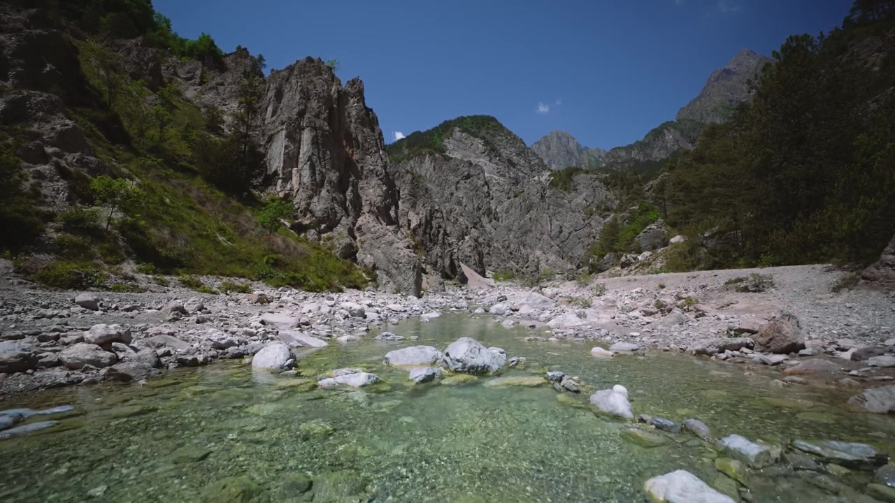 Acqua di torrente di montagna che scorre impetuosa sulle pietre, Dolomiti Friulane, Italia settentrionale. Vista dal basso.