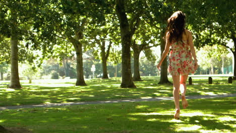 Attractive-brunette-bouncing-through-park