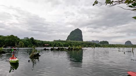 kayakers explore scenic canal in krabi, thailand