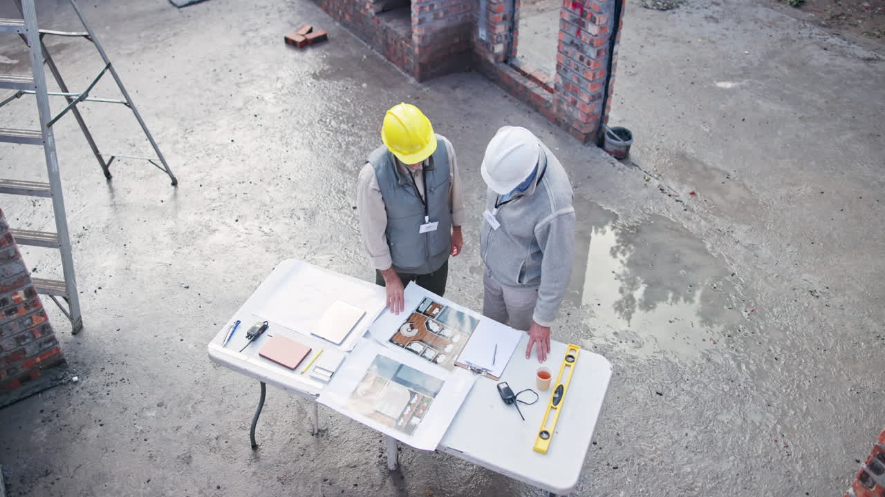 Construction Workers Reviewing Plans on Site