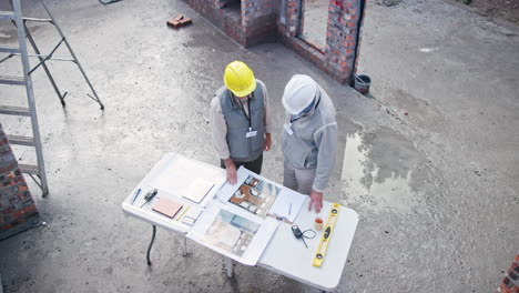 construction workers reviewing plans on site