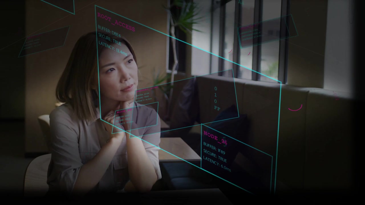 Studying adult Asian woman scanning holographic panels in lounge near windows, wearing light blouse
