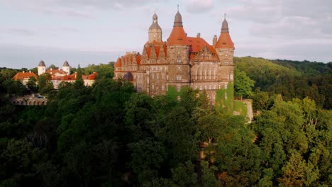 aerial view of a historic castle surrounded by forest