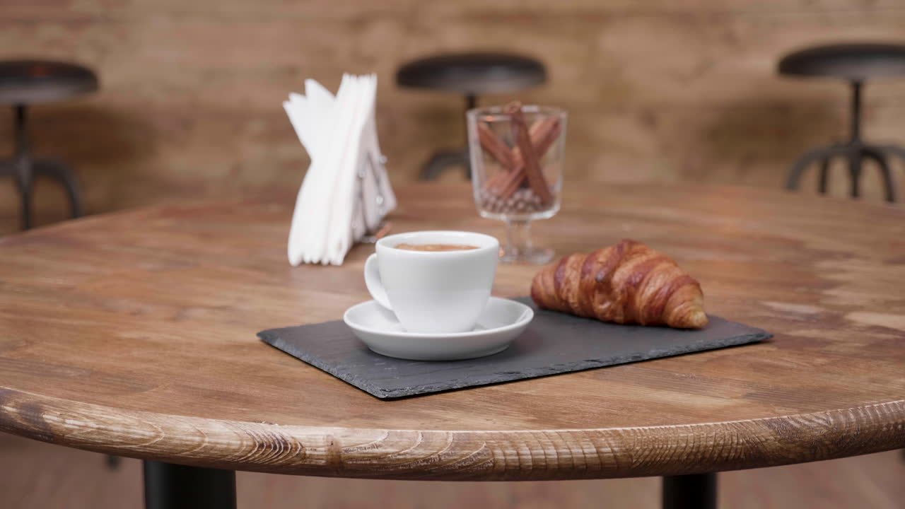 Coffee and croissant on a table