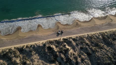 Two-vehicles-parking-on-sandy-beach-in-Australia