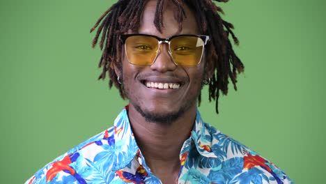 young happy handsome african tourist man smiling while wearing sunglasses
