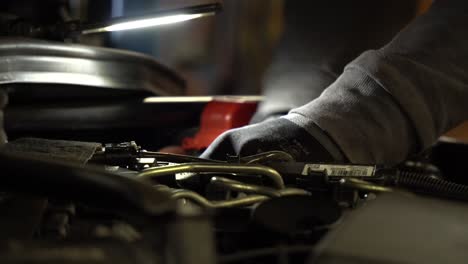 mechanic in uniform repair the motor of car