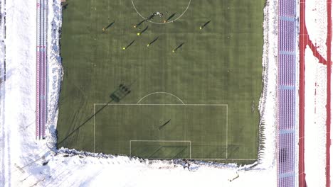 football club on the winter preparations on the artificial grass, from the top , drone 4k