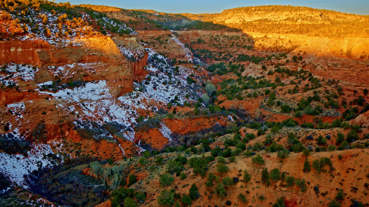 Flying over sculpted red sandstone near Page, Arizona in a sweeping aerial shot.