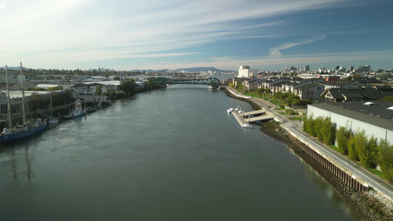 Sweeping drone views reveal the Park Street Bridge spanning the Tidal Canal, linking Alameda and Oakland.