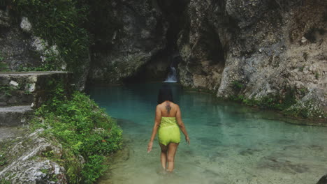 woman swimming in beautiful balneario mata de maiz waterfall in the dr