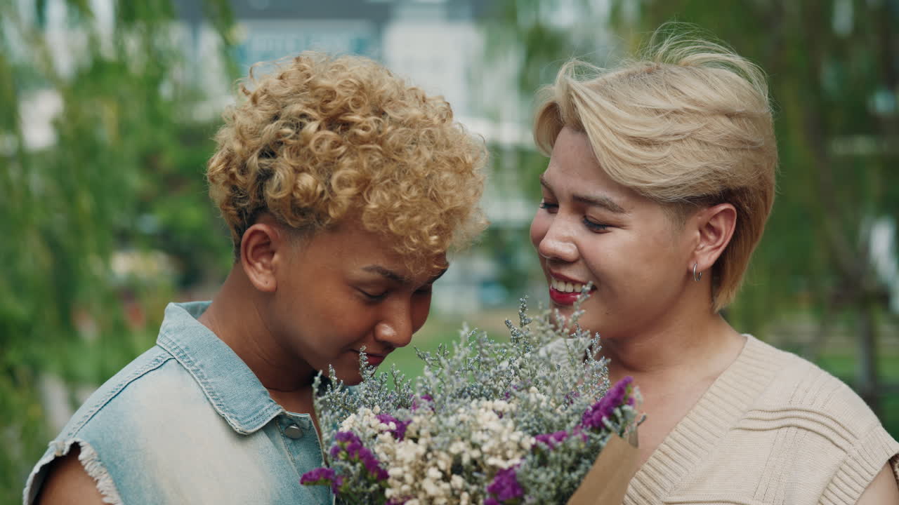 Happy LGBTQ Couple with Flowers