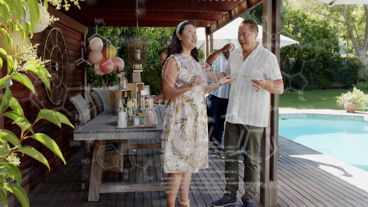 Mature couple greeting, offering drink, clinking glasses by pergola dining table for event planning