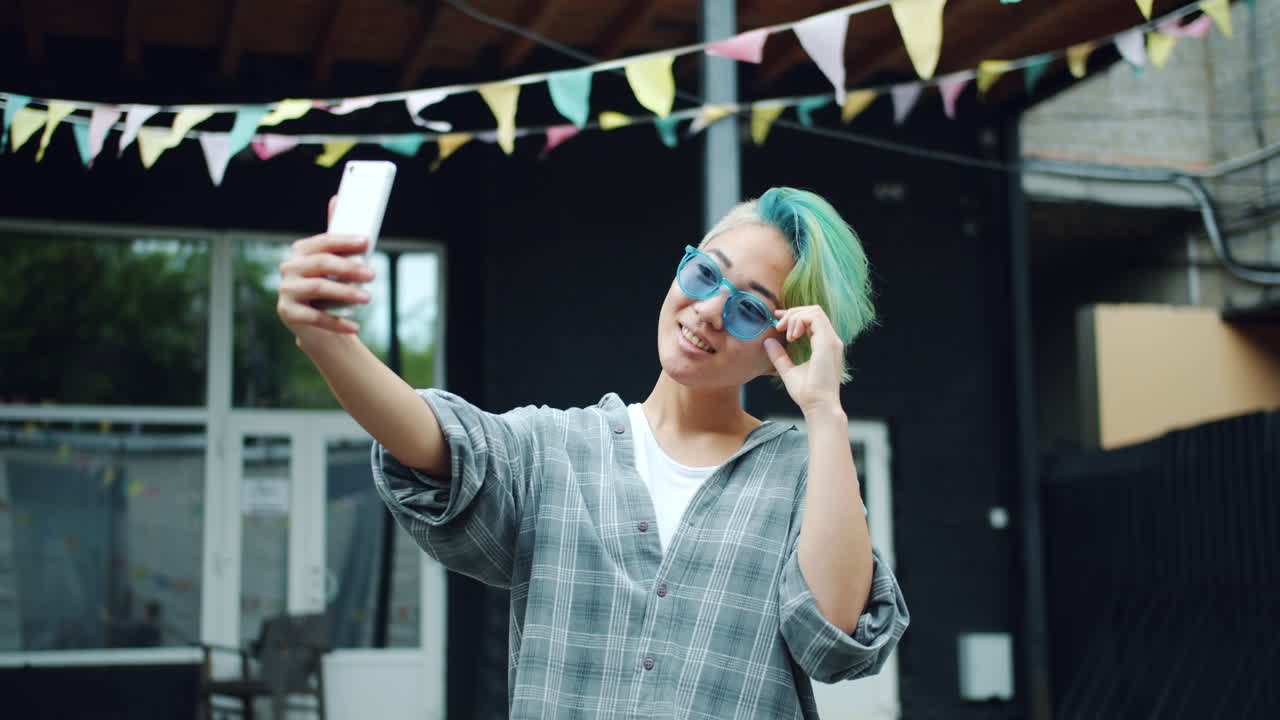 Young Woman Taking a Selfie Outdoors
