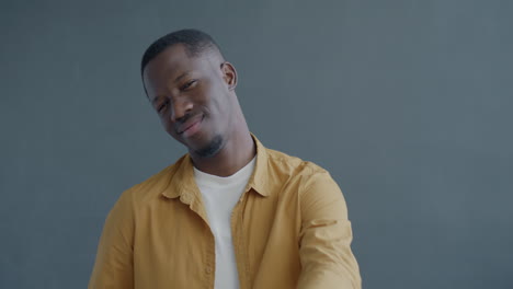man posing in yellow shirt