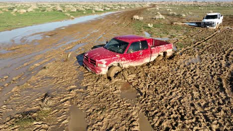 Unusual-torrential-rains-in-the-Mojave-Desert-leave-trucks-stuck-in-the-mud---aerial-orbit