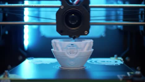 a close-up view of a 3d printer as it constructs a multi-layered bowl with precise attention to detail and vibrant led lighting in action