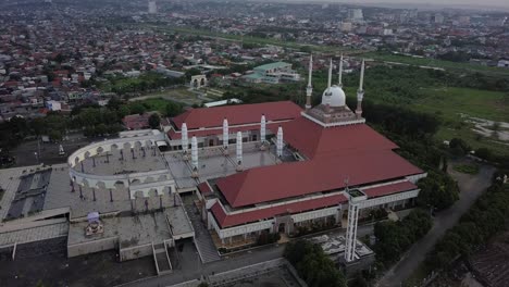aerial view of the great mosque of central java (majt) in suset time. th sun is orange and the weather is cloudy. point of interest drone shot