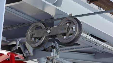 close-up of cable car wheels and steel rope mechanism at winter resort