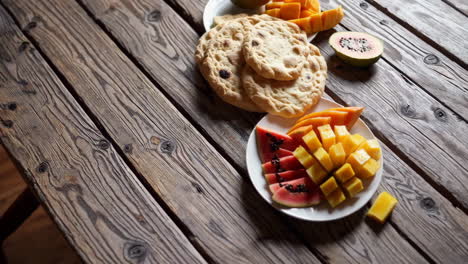 fruit platter with roti on a wooden table
