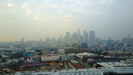 overcast misty aerial view across downtown los angeles cityscape high rise skyline dolly right