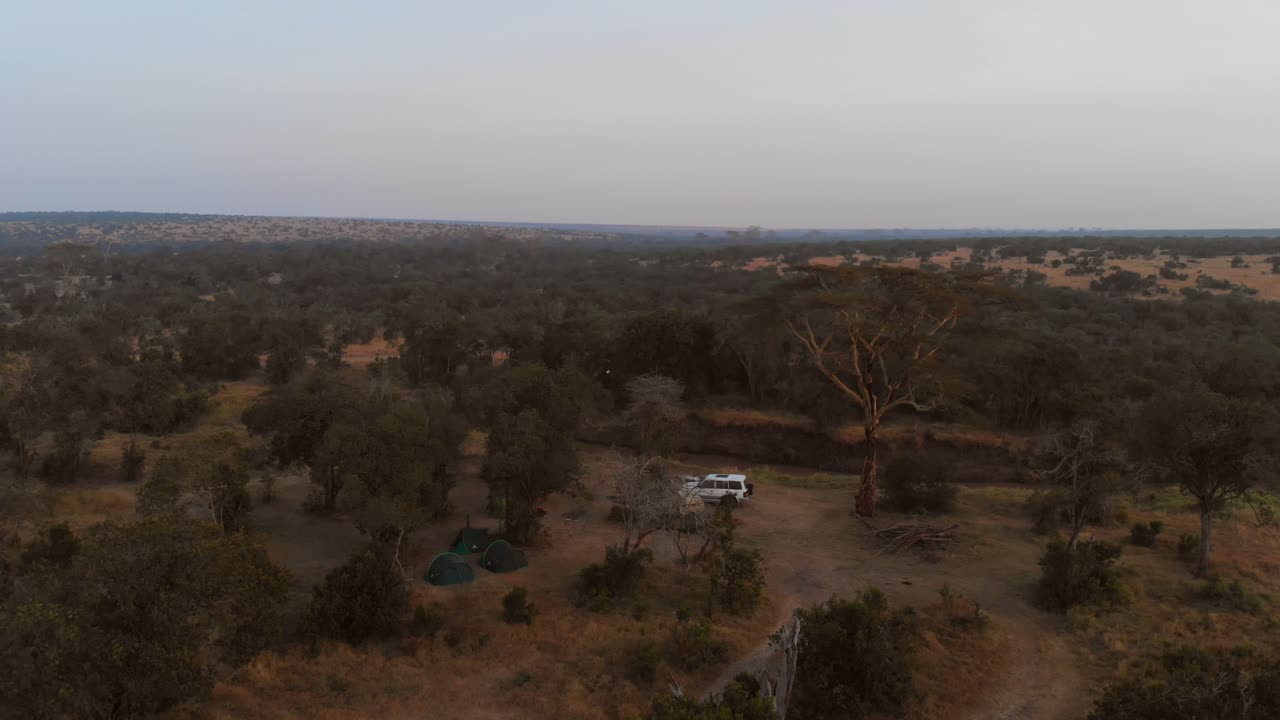 Sunrise near a river and campsite in Ol Pejeta, Kenya