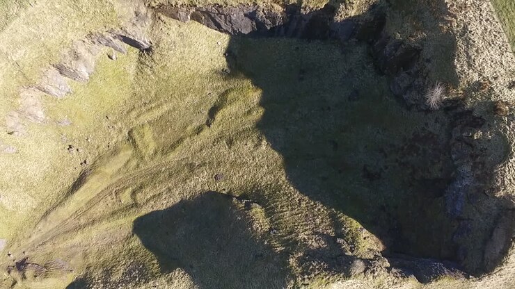 Aerial top down view of a disused quarry in the English countryside on a bright sunny day