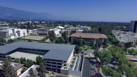 Cal-Tech-campus,-aerial-pullback-of-rooftops-over-buildings,-clear-day-in-Pasadena