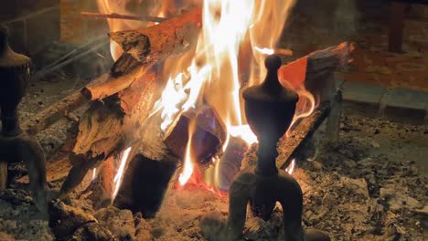 fire in an open cosy fireplace indoor, in the background chairs on a carpeting, 30 degree angle view