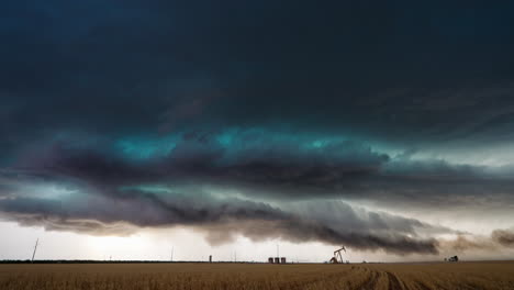 dramatic storm clouds and dust rolling over a rural oil field