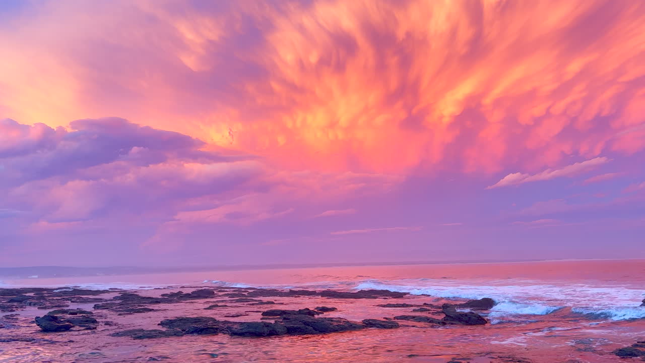 JBay Jefferey's Bay South Africa most stunning best ever incredible summer sunset thunderstorm clouds golden orange red pink waves crash on coastline shore God creation surf paradise pan left