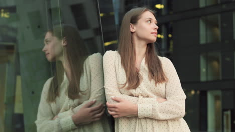 woman leaning on showcase of building