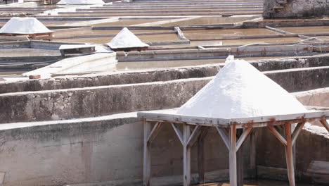 salt drying on wooden tables at rio maior salt pans in portugal