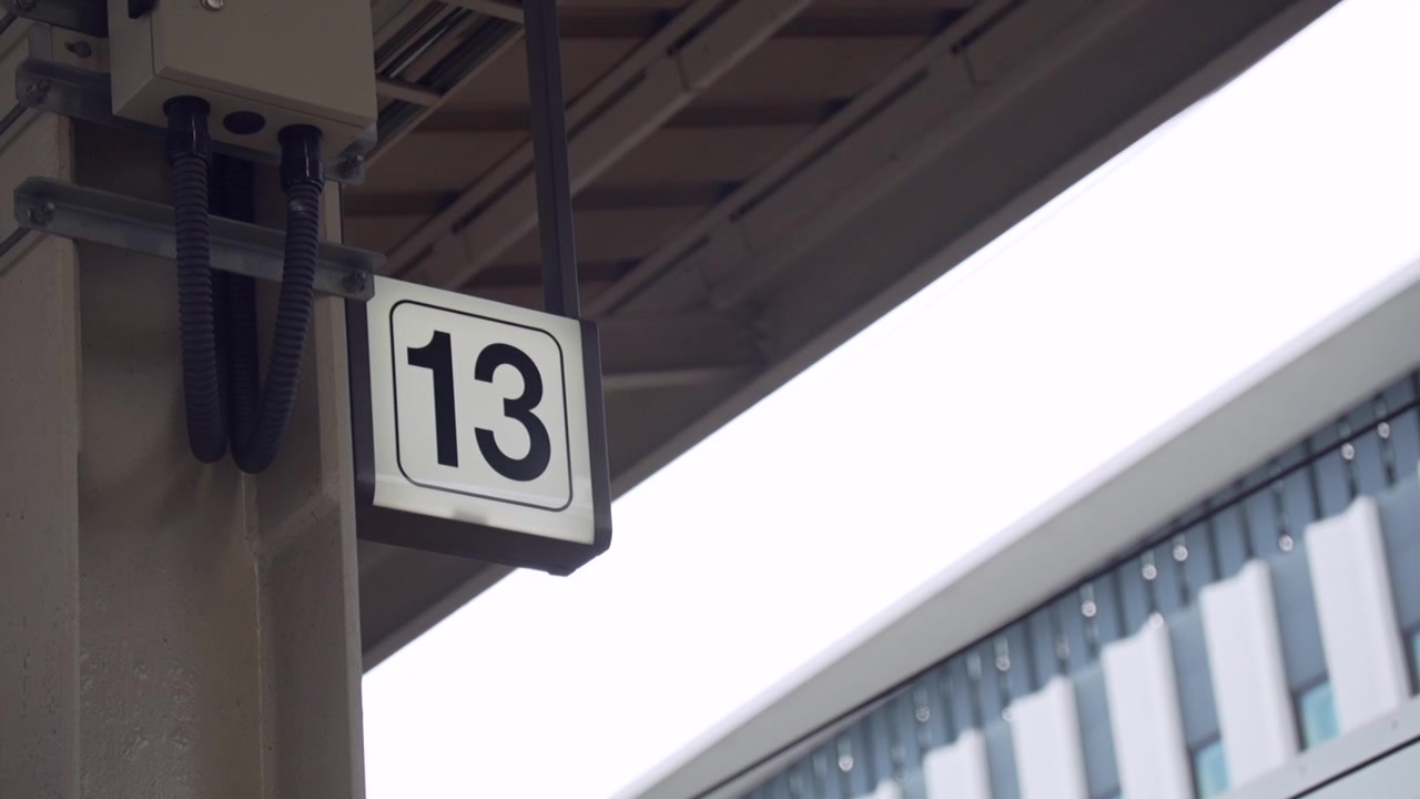 A close-up of the sign indicating platform number 13 at a Japanese train station. A detailed shot capturing the essence of daily life and public transport in Japan.