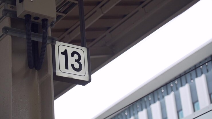 A close-up of the sign indicating platform number 13 at a Japanese train station. A detailed shot capturing the essence of daily life and public transport in Japan.