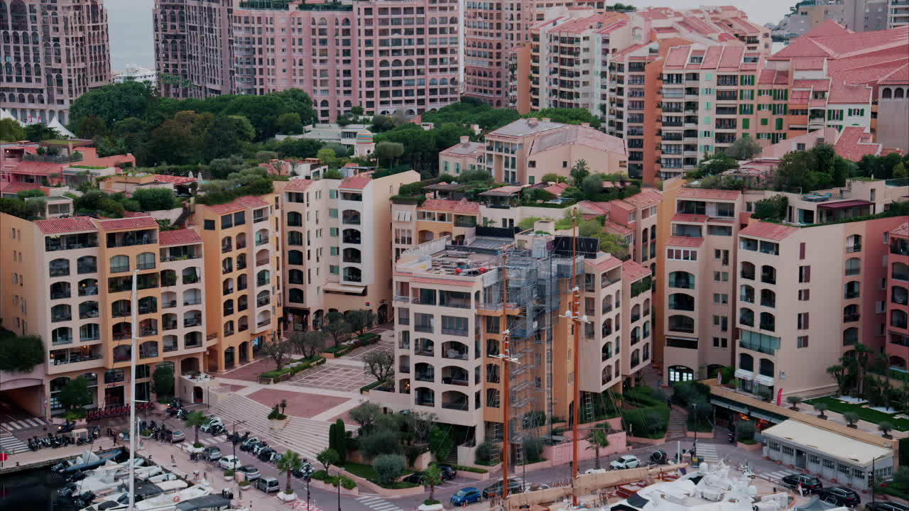 View of boats docked in the Monaco Marina with the skyline of the city on the background