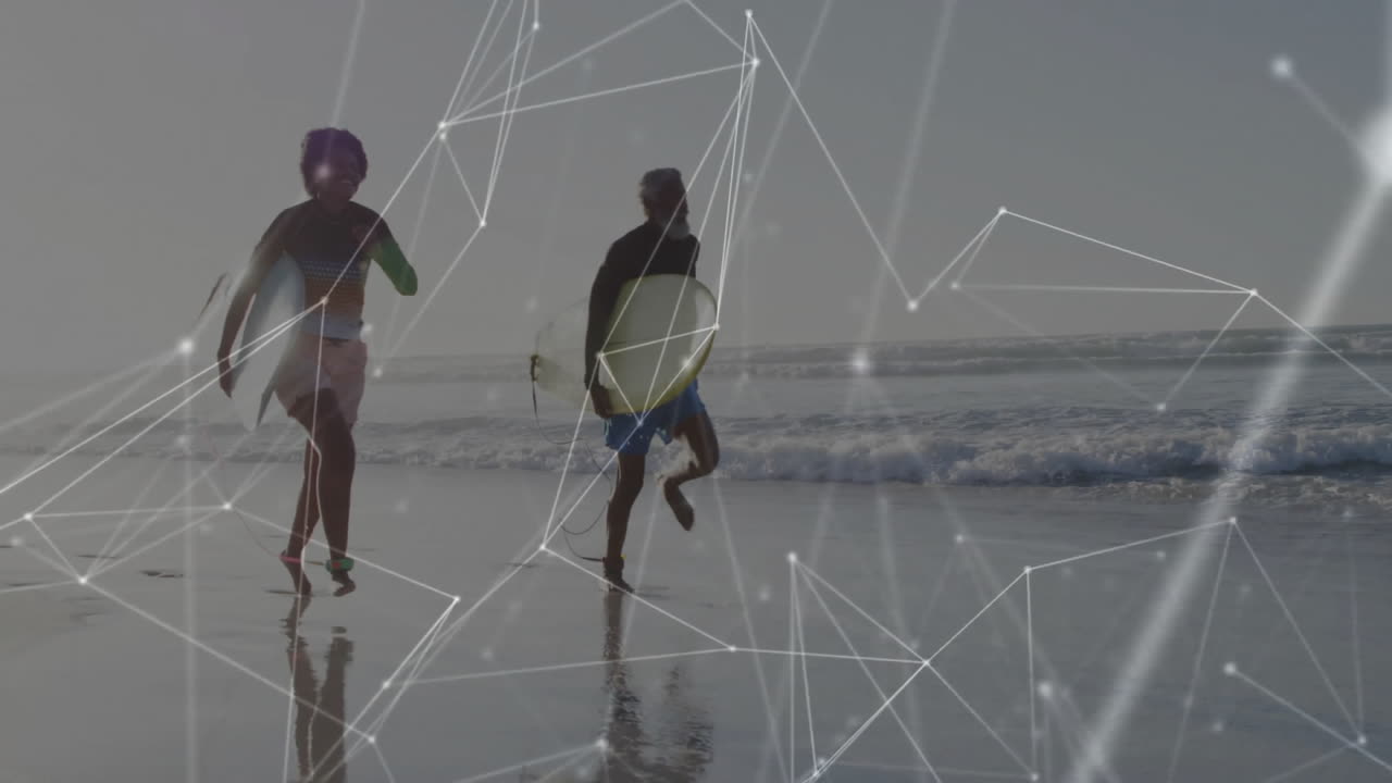 female and male surfers with surfboards running on beach, showcasing network overlay for tech ads