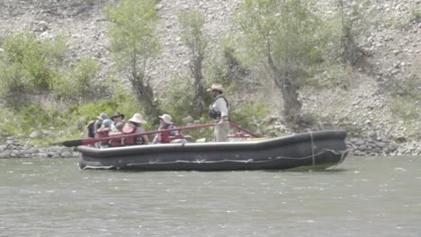 group of people floating down river in raft